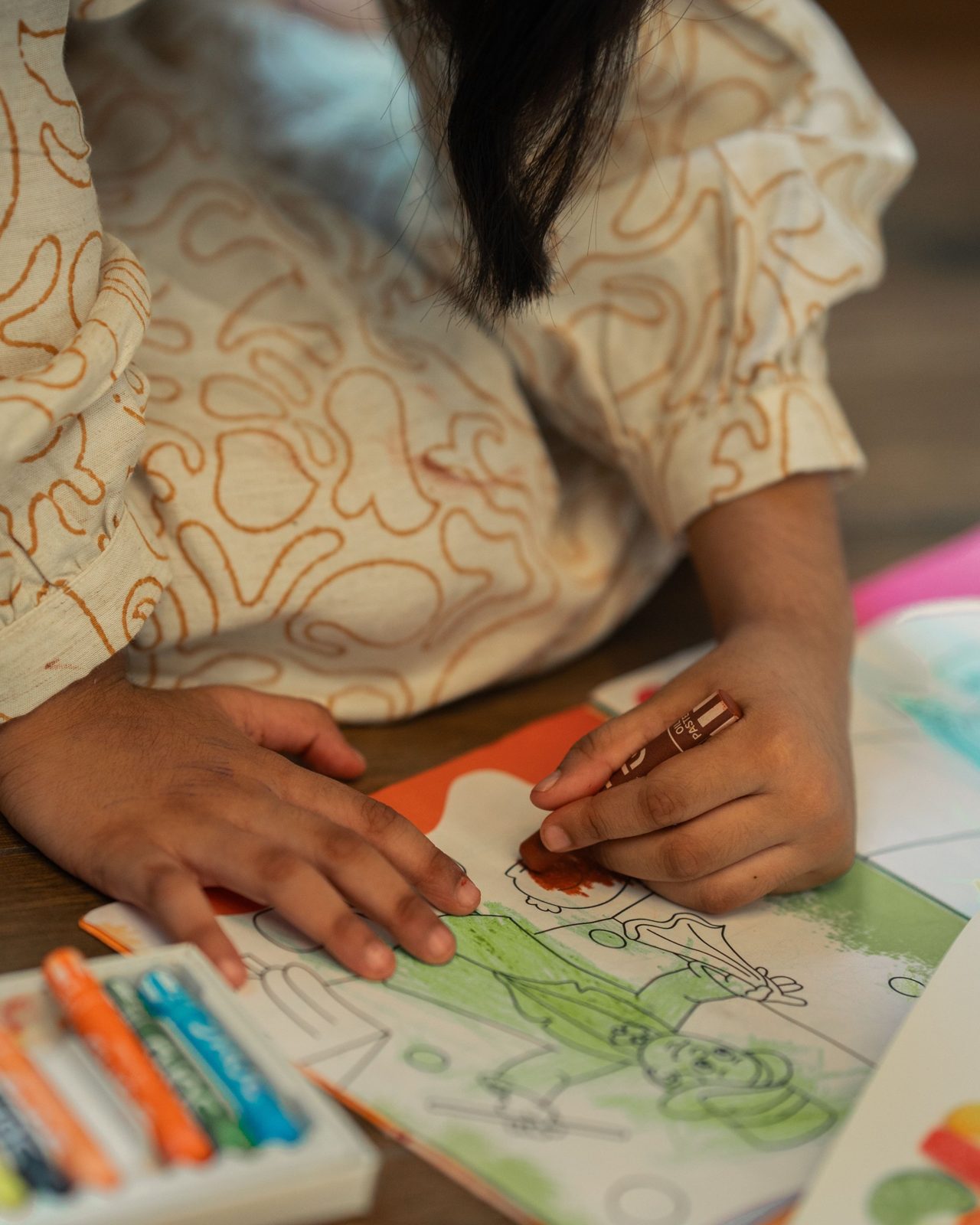 Niña coloreando un dibujo con ceras, terapia infantil en Valladolid